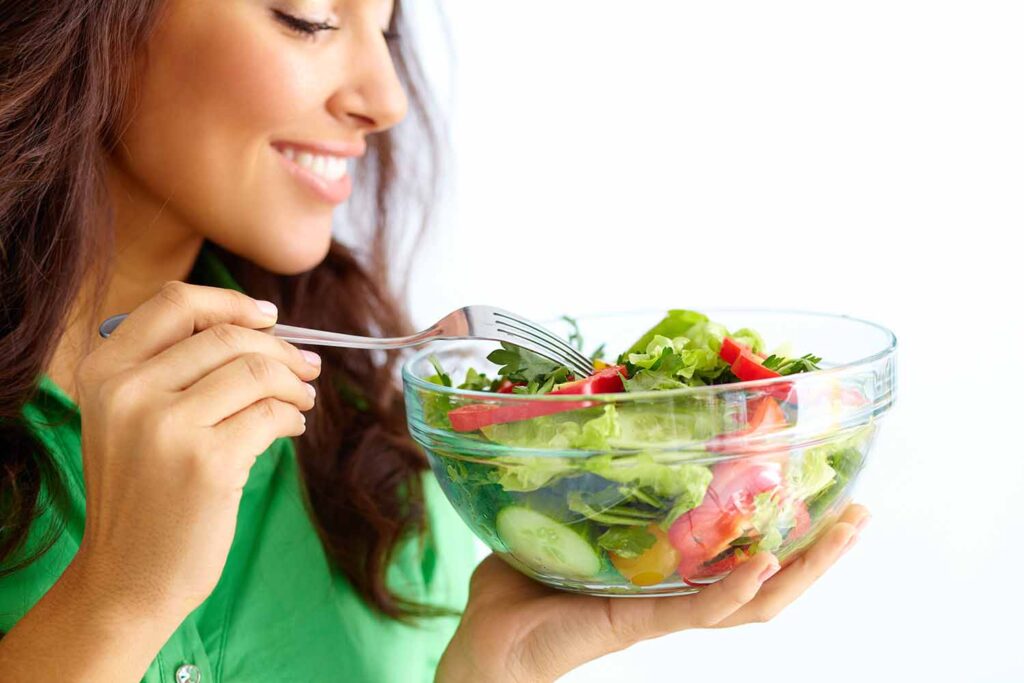 Call Center English, talking about Healthy Lifestyle Choices, Close-up of pretty girl eating fresh vegetable salad